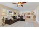 Cozy living room with view to the kitchen, large windows, and comfortable furnishings at 1314 E Bluefield Ave, Phoenix, AZ 85022