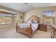 Spacious main bedroom featuring a decorative bed frame, two windows and a ceiling fan at 1314 E Bluefield Ave, Phoenix, AZ 85022