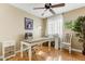 Home office with a white desk, file cabinet, decorative chair, and hardwood floors at 1314 E Bluefield Ave, Phoenix, AZ 85022