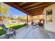 Charming covered patio with comfortable seating and a view of the sparkling pool and lush backyard at 1314 E Bluefield Ave, Phoenix, AZ 85022