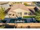 Overhead view of the property revealing the sparkling pool, covered patio, and lush backyard landscaping at 13568 N 144Th Dr, Surprise, AZ 85379
