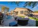 Inviting backyard featuring a swimming pool, fire pit, and lounge seating area at 13568 N 144Th Dr, Surprise, AZ 85379