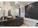 Contemporary bathroom features dual sinks, soaking tub, and a frameless glass shower for a spa-like retreat at 13568 N 144Th Dr, Surprise, AZ 85379