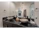 Bathroom with dual vessel sinks, granite countertops, and stylish fixtures offer comfort and elegance at 13568 N 144Th Dr, Surprise, AZ 85379