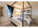 Cozy bedroom featuring a four-poster bed with soft lighting and stylish decor at 13568 N 144Th Dr, Surprise, AZ 85379