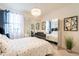 Bright bedroom showcases mirrored closet doors and a large window for ample natural light at 13568 N 144Th Dr, Surprise, AZ 85379