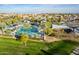 Enjoy the outdoors at this community pool and lounging area with shade covers and nearby playground at 13568 N 144Th Dr, Surprise, AZ 85379