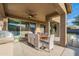 Inviting covered patio area with ceiling fan, grill, and ample space for outdoor dining and entertaining at 13568 N 144Th Dr, Surprise, AZ 85379