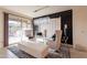 Bright dining area with a glass-top table, statement lighting, and a sliding door at 13568 N 144Th Dr, Surprise, AZ 85379