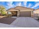 Charming single-story home featuring a two-car garage and desert landscaping at 13568 N 144Th Dr, Surprise, AZ 85379