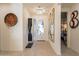 Bright foyer with modern lighting fixtures and stylish decorative art pieces at 13568 N 144Th Dr, Surprise, AZ 85379
