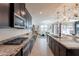 Open kitchen design with stainless steel appliances, granite counters, and views to the living area at 13568 N 144Th Dr, Surprise, AZ 85379