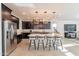 Modern kitchen with granite island, stainless steel appliances, and breakfast bar seating at 13568 N 144Th Dr, Surprise, AZ 85379