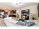 Spacious open-concept living room showcasing contemporary decor and modern lighting fixtures at 13568 N 144Th Dr, Surprise, AZ 85379