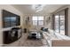 Cozy living room with a plush white sectional sofa, media center and a large TV at 13568 N 144Th Dr, Surprise, AZ 85379