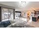 Bright open-concept living room with tile flooring, modern lighting, and access to the patio at 13568 N 144Th Dr, Surprise, AZ 85379