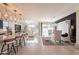Open concept living space with tile floors, a modern kitchen, a cozy living area, and dining space at 13568 N 144Th Dr, Surprise, AZ 85379