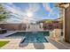 Stunning pool with waterfall feature and decorative planters, perfect for outdoor relaxation and entertainment at 13568 N 144Th Dr, Surprise, AZ 85379