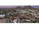 Aerial view pinpointing a modern home within a neighborhood with mountain views at 14025 N 11Th Pl, Phoenix, AZ 85022