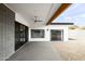 Modern back patio with block wall, ceiling fan and access to the yard at 14025 N 11Th Pl, Phoenix, AZ 85022