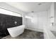 Modern bathroom featuring a soaking tub, a walk-in shower, white tile, and a black marble accent wall at 14025 N 11Th Pl, Phoenix, AZ 85022