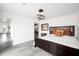 Stylish bedroom with a dark wood bed frame, unique lighting fixture, and sliding door access to the backyard at 14025 N 11Th Pl, Phoenix, AZ 85022