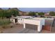 Beautiful modern home with a gray garage door, desert landscaping, and mountain views at 14025 N 11Th Pl, Phoenix, AZ 85022