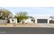 Contemporary home with desert landscaping and a gray two-car garage door at 14025 N 11Th Pl, Phoenix, AZ 85022