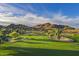 Scenic golf course view with lush green fairways, sand traps, and mountain backdrop at 14025 N 11Th Pl, Phoenix, AZ 85022