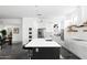 Open-concept kitchen featuring an island with seating, stainless steel appliances, and ample counter space at 14025 N 11Th Pl, Phoenix, AZ 85022