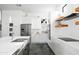 Modern white kitchen with stainless steel appliances, a large island, and sleek cabinetry at 14025 N 11Th Pl, Phoenix, AZ 85022