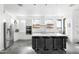 Bright, modern kitchen with stainless steel appliances, large island with seating, and stylish pendant lights at 14025 N 11Th Pl, Phoenix, AZ 85022
