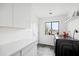 Laundry room features sleek countertops, modern appliances, and a window with view to the backyard at 14025 N 11Th Pl, Phoenix, AZ 85022
