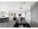 Open-concept living room features modern lighting, concrete floors and access to the backyard through large sliding glass doors at 14025 N 11Th Pl, Phoenix, AZ 85022