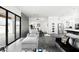 Open-concept living room boasts gray concrete floors, modern furnishings, and a large sliding glass door to the backyard at 14025 N 11Th Pl, Phoenix, AZ 85022