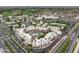 Aerial view of a resort featuring a central pool, tropical landscaping, and well-maintained buildings at 14474 W Lexington Ave, Goodyear, AZ 85395