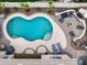 Aerial view of the private backyard featuring a pool, fireplace, and outdoor kitchen at 14474 W Lexington Ave, Goodyear, AZ 85395