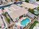 Aerial view of home's private backyard oasis featuring a pool, fireplace, outdoor kitchen, and pergola at 14474 W Lexington Ave, Goodyear, AZ 85395