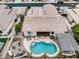 Aerial view of the private backyard featuring a pool, fireplace, outdoor kitchen, and pergola at 14474 W Lexington Ave, Goodyear, AZ 85395