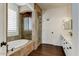 Luxurious bathroom with a soaking tub, glass-enclosed shower, and double vanity at 14474 W Lexington Ave, Goodyear, AZ 85395