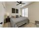 Cozy bedroom featuring a decorative ceiling fan and a neutral-toned, patterned duvet cover at 14474 W Lexington Ave, Goodyear, AZ 85395