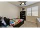 Bright bedroom boasts a playful character theme, complete with a dark bookshelf and ample natural light at 14474 W Lexington Ave, Goodyear, AZ 85395