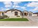 Charming single-story home with manicured lawn, complemented by desert landscaping and a welcoming facade at 14474 W Lexington Ave, Goodyear, AZ 85395