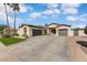 Beautiful single-story home with a three-car garage, desert landscaping, and a well-maintained driveway at 14474 W Lexington Ave, Goodyear, AZ 85395