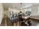 Bright and airy kitchen and dining area featuring white cabinets, a central island, and modern appliances at 14474 W Lexington Ave, Goodyear, AZ 85395