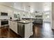 Open concept kitchen with stainless steel appliances, granite countertops, and seamless flow to dining and living spaces at 14474 W Lexington Ave, Goodyear, AZ 85395