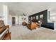 Open-concept living room with leather chairs, a piano, and a stylish dry bar, ideal for entertaining at 14474 W Lexington Ave, Goodyear, AZ 85395