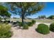 Beautiful landscaped park area featuring lush greenery, mature trees, and colorful flowers, ideal for relaxing at 14474 W Lexington Ave, Goodyear, AZ 85395