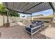 Backyard patio with custom pergola, tv, and outdoor seating at 14474 W Lexington Ave, Goodyear, AZ 85395