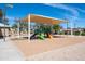 Inviting shaded playground with colorful slides and climbing structures, located in well maintained community park at 14474 W Lexington Ave, Goodyear, AZ 85395